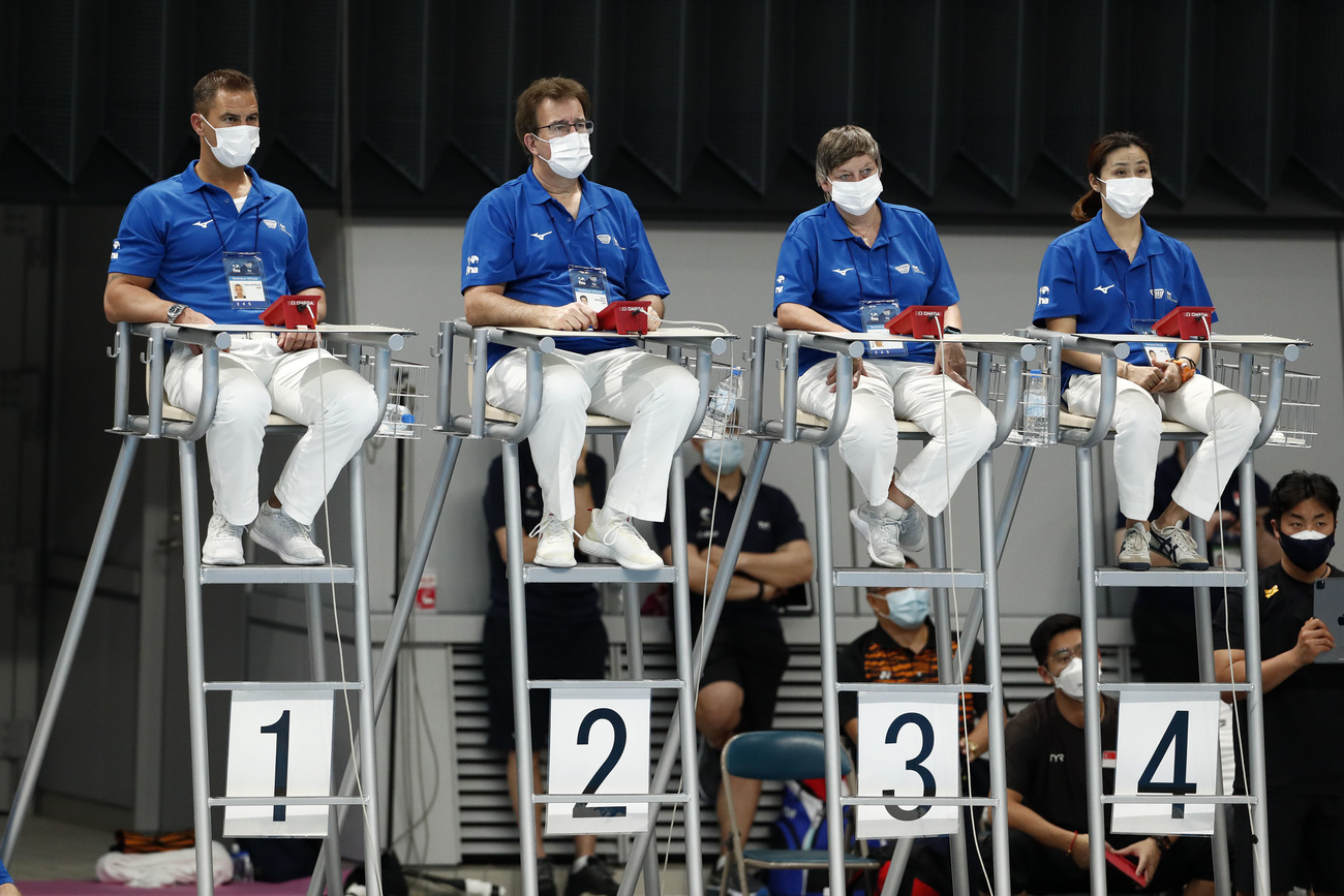 coaches oversee a swim competition