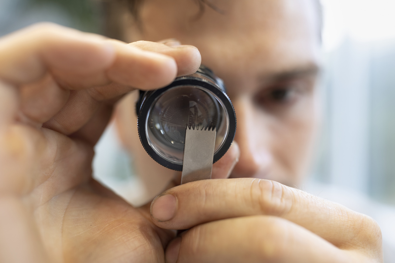 An employee checks an oscillating surgical bone saw blade at the company Gomina.