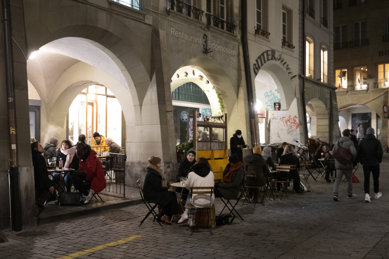 People sitting at restaurant tables outside