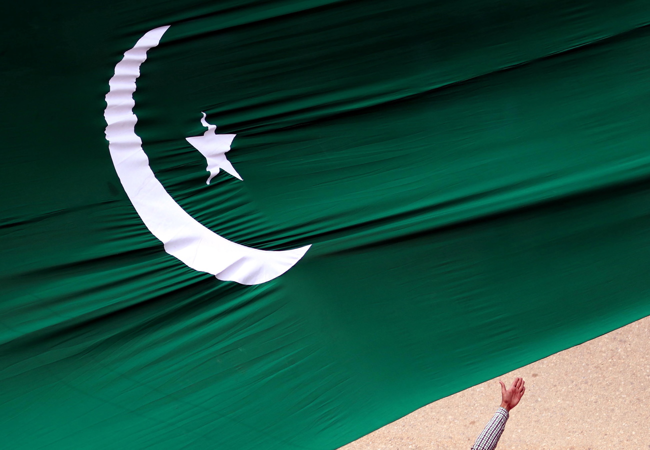 Flag of Pakistan and hand beneath