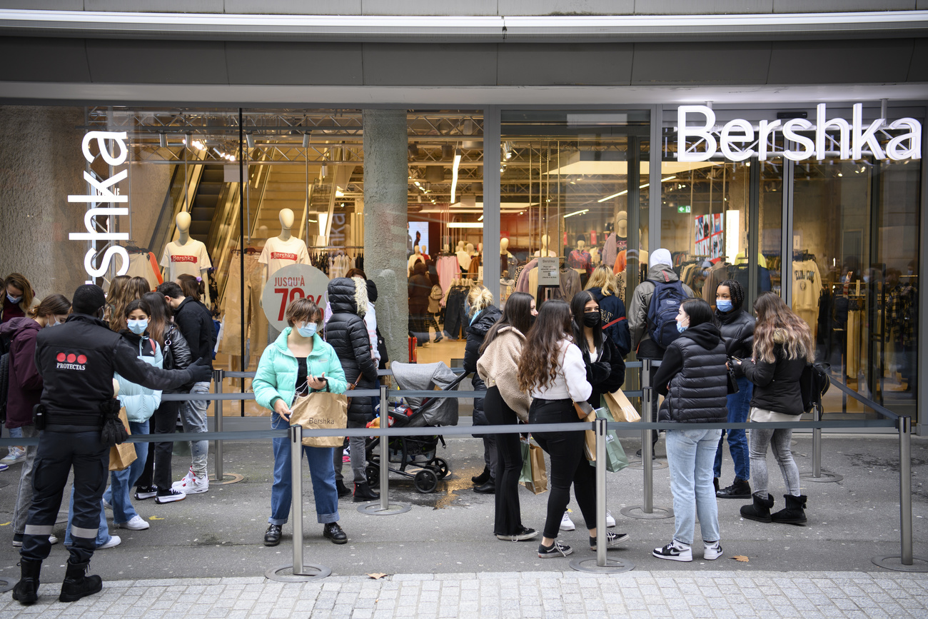 Masked shoppers queue up