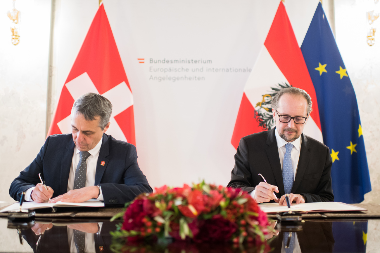 Foreign Ministers of Switzerland and Austria signing a document