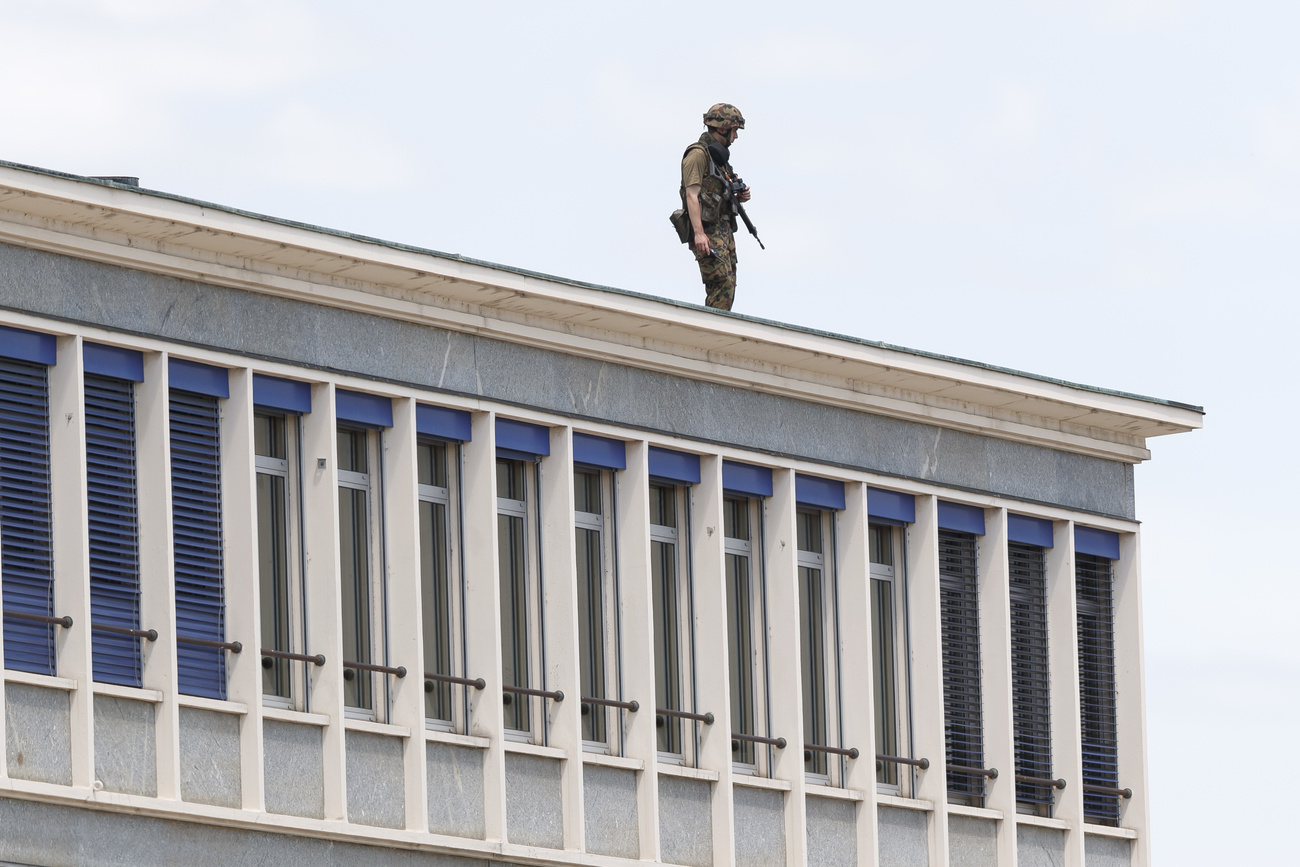 A soldier on the roof of a building near the airport awaits the arrival of United States President Joe Biden.