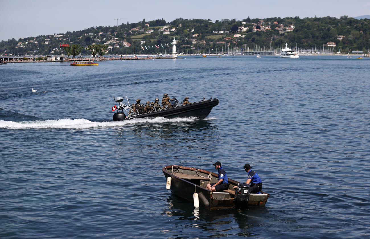 Police and military officers patrol the Lake of Geneva