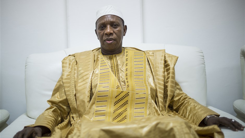 رجل جالس على أريكة مرتديا زيا تقليديا من مالي