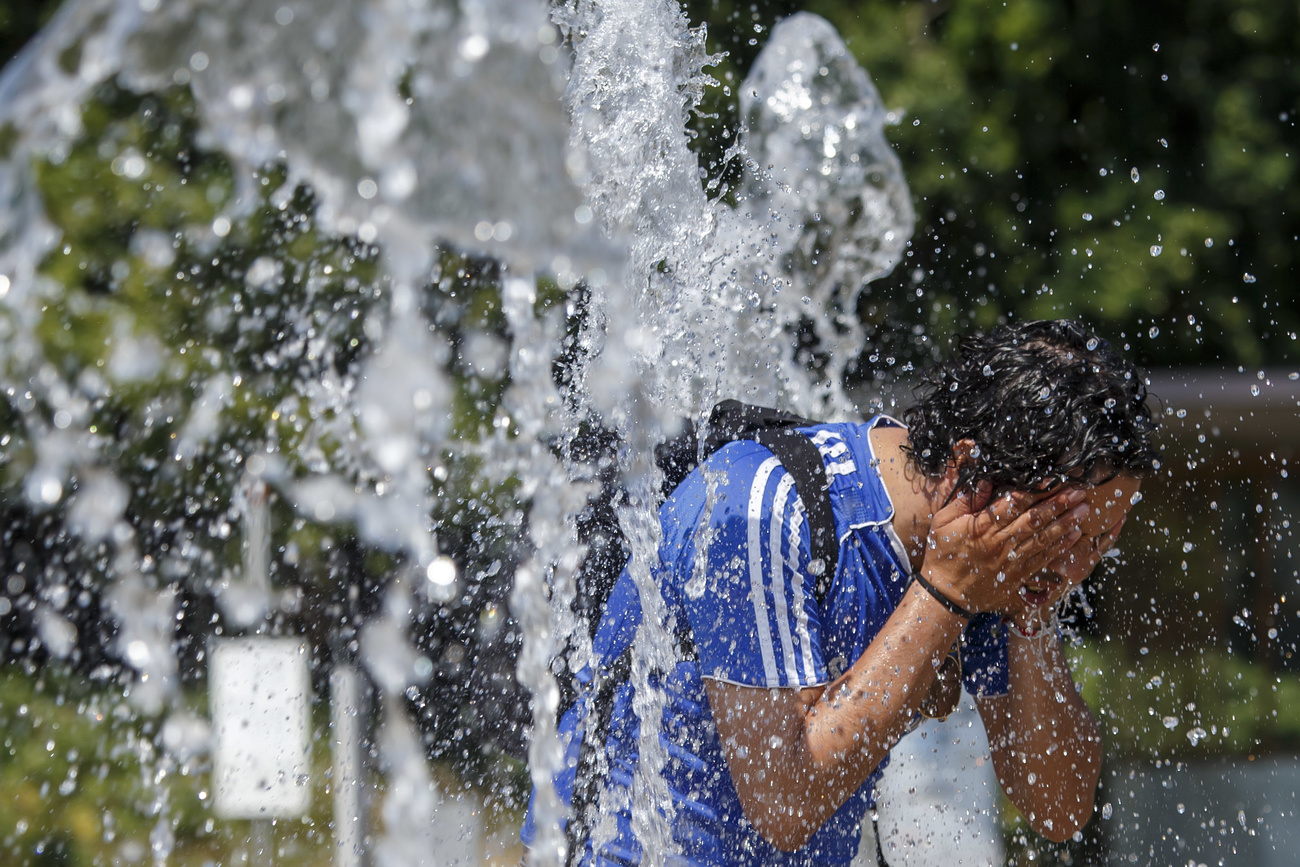 man cooling off in fountain