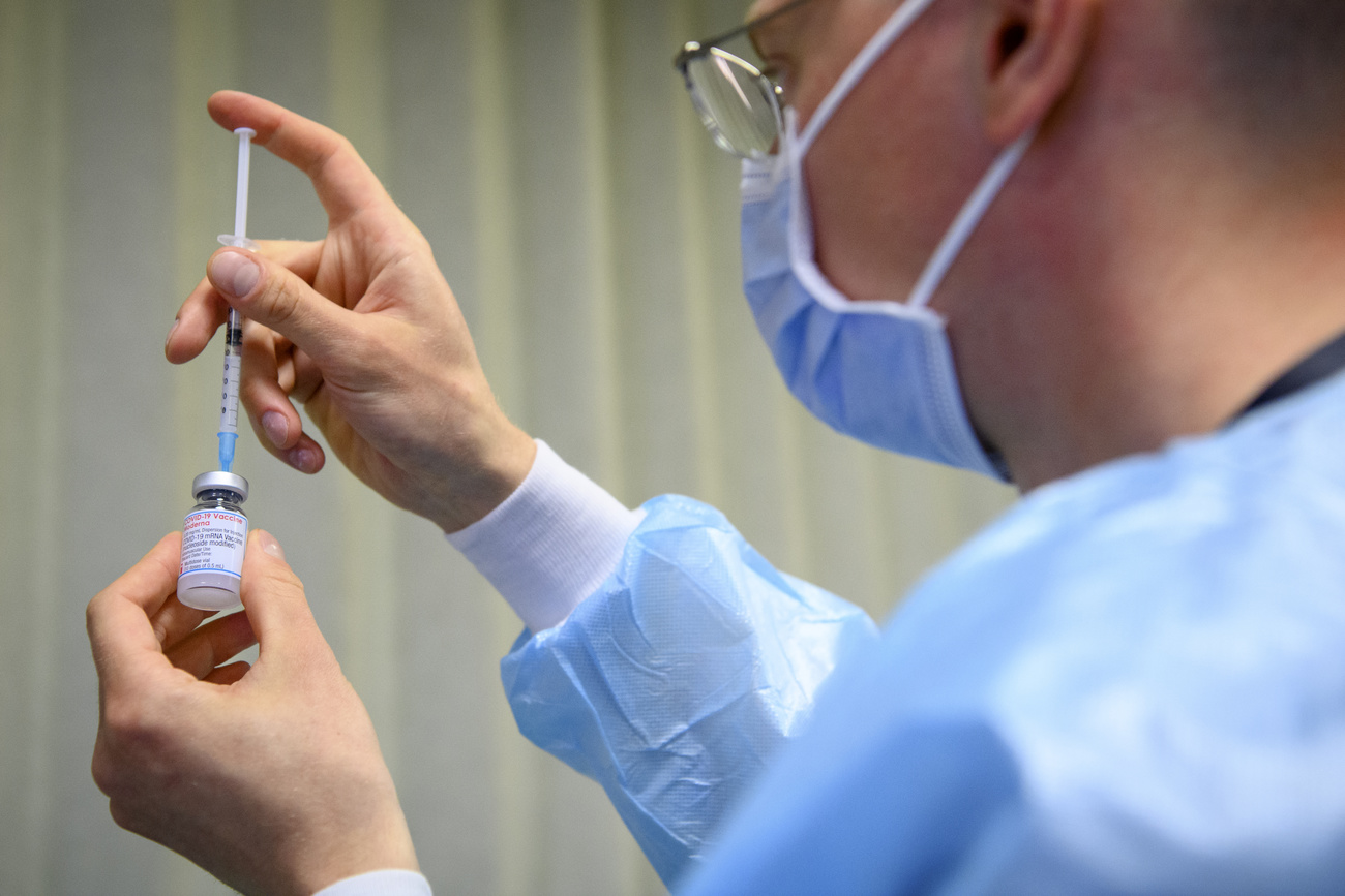 medical worker prepares vaccine shot