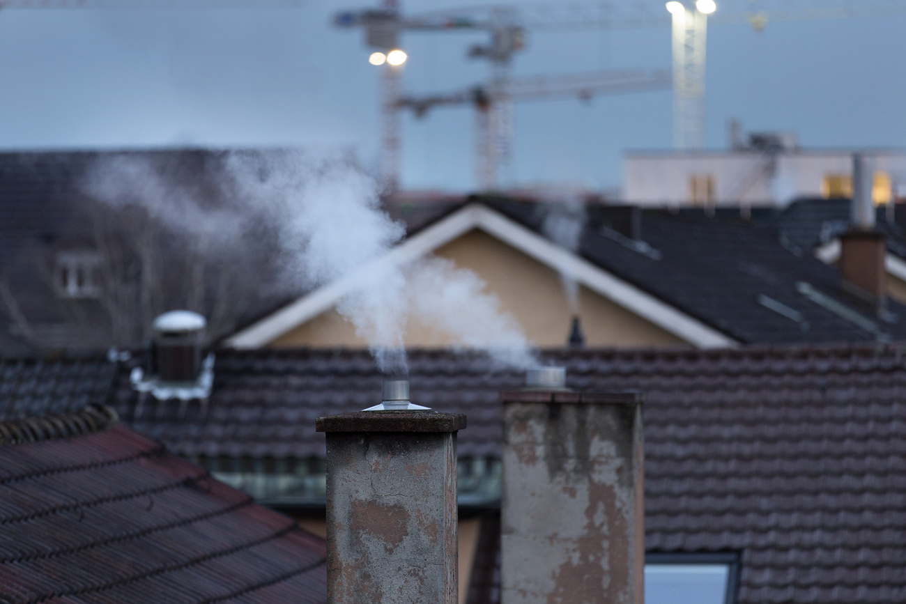 Smoking chimneys, rooftops and cranes