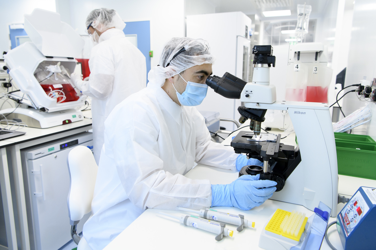 Scientist looking through microscope