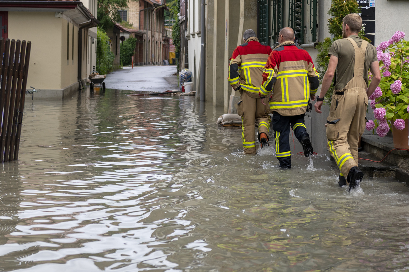 Sauveteurs dans une rue inondée.