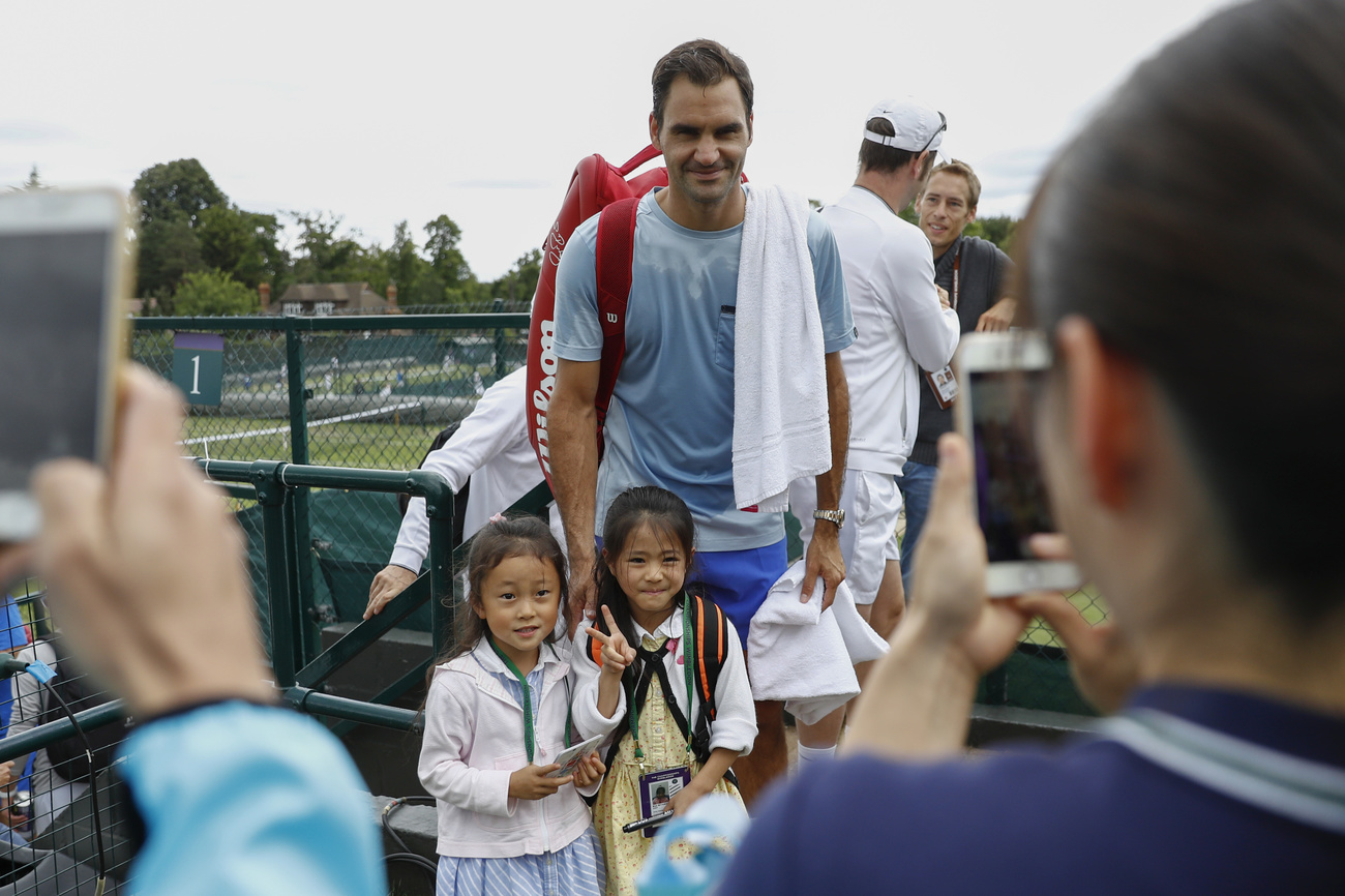 Federer poses with two young girls