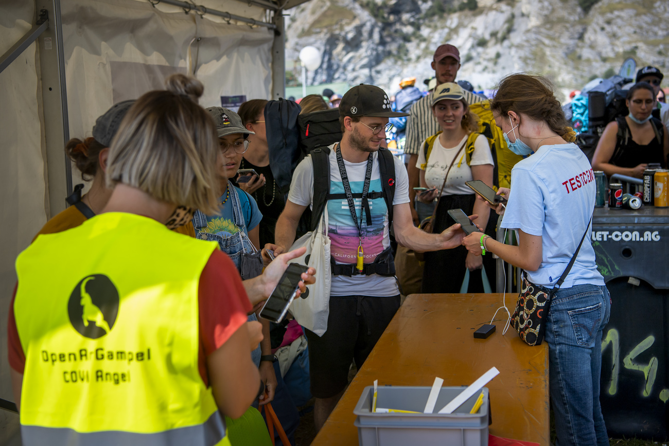 Festival-goers show their Covid certificate at the entrance of the Openair Gampel event.