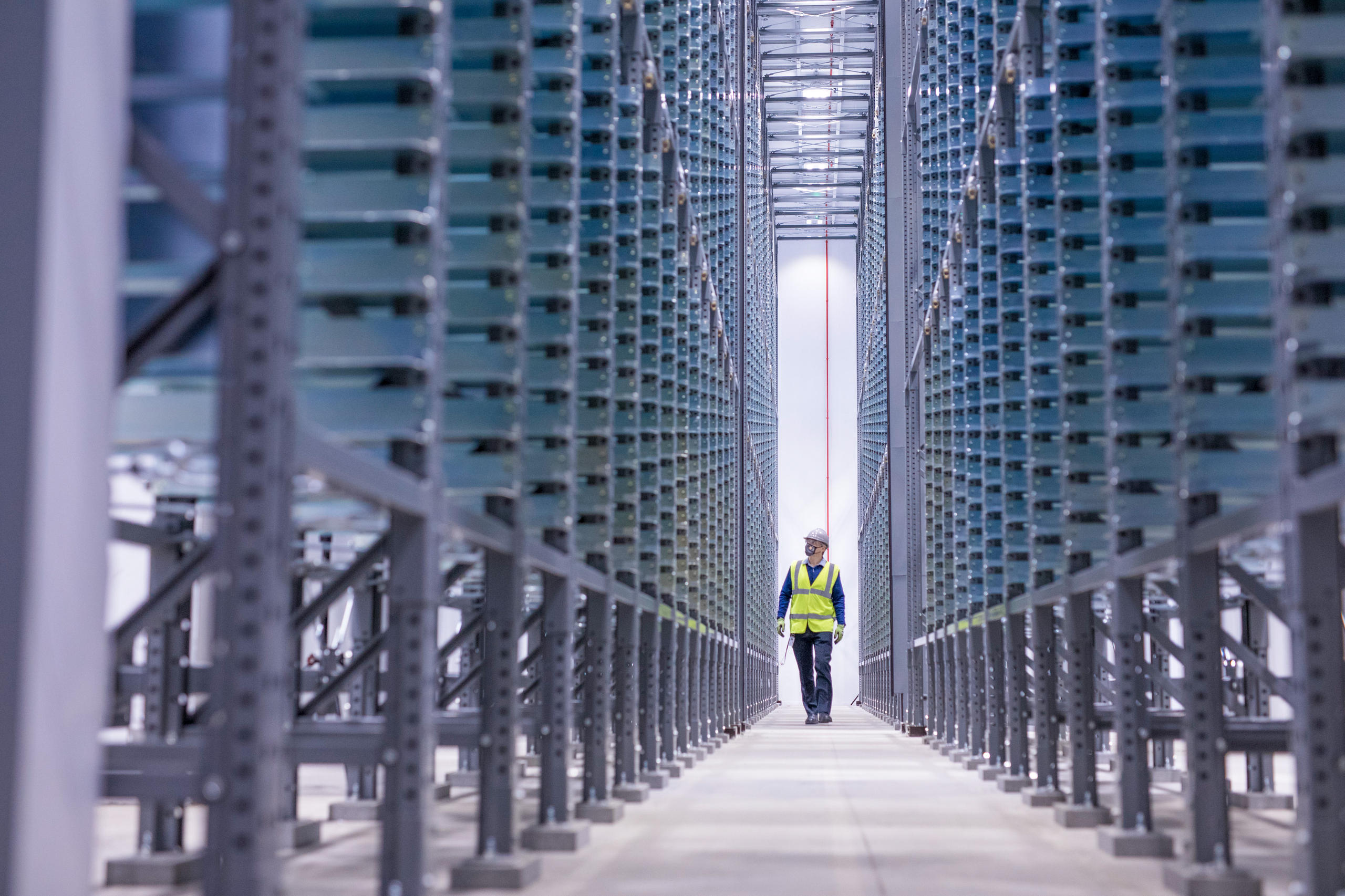 Man walking down gigafactory passage