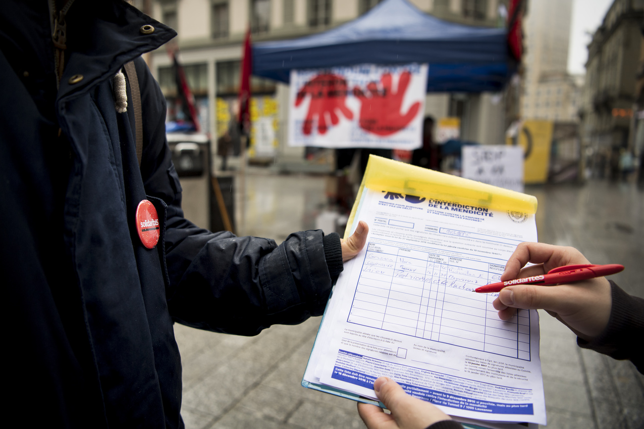 Campainger collecting signatures from citizens in a street