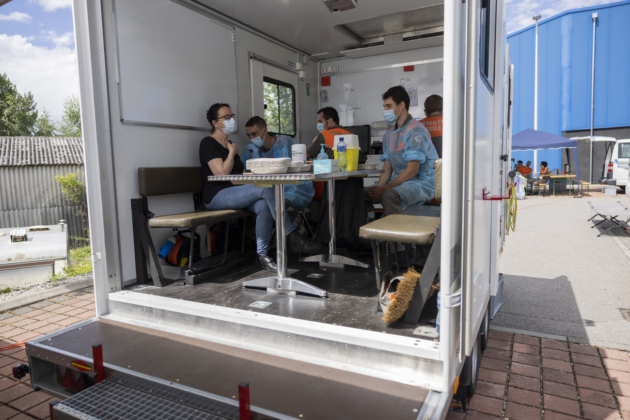 persone nel retro di un camion, una di loro si fa vaccinare