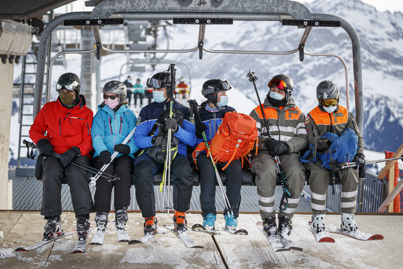 Masked skiiers on lift