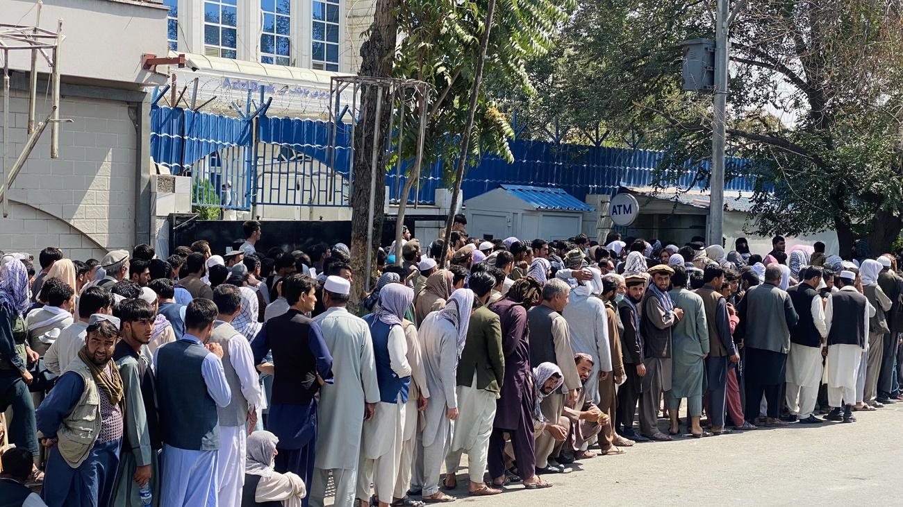 Afghans line up outside a bank in Kabul.