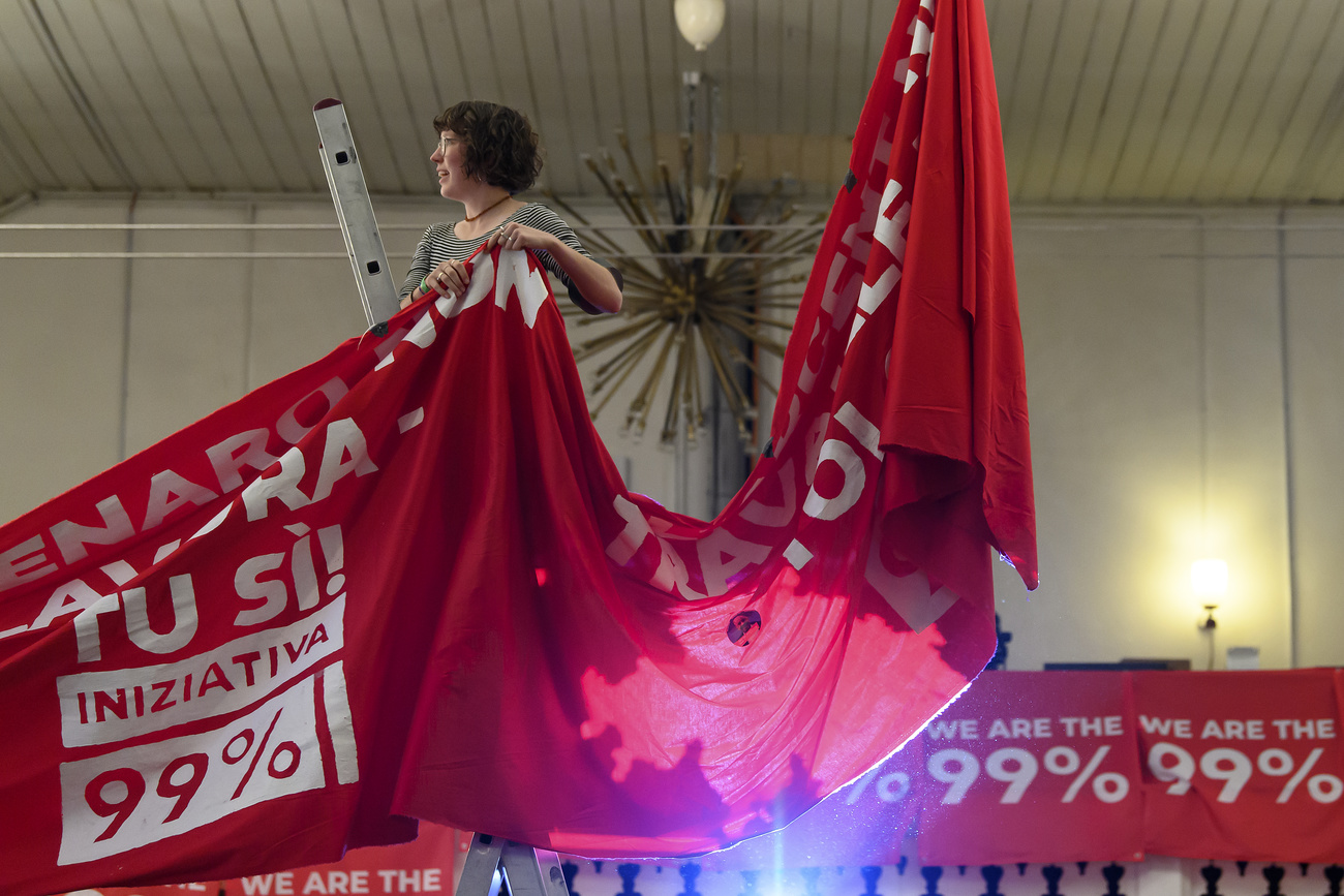 Campaigner with banner for 99% initiative
