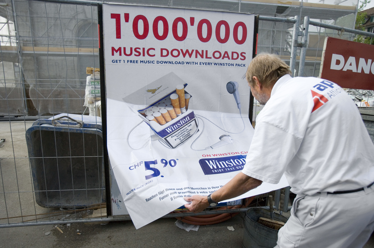 Man putting up smoking poster