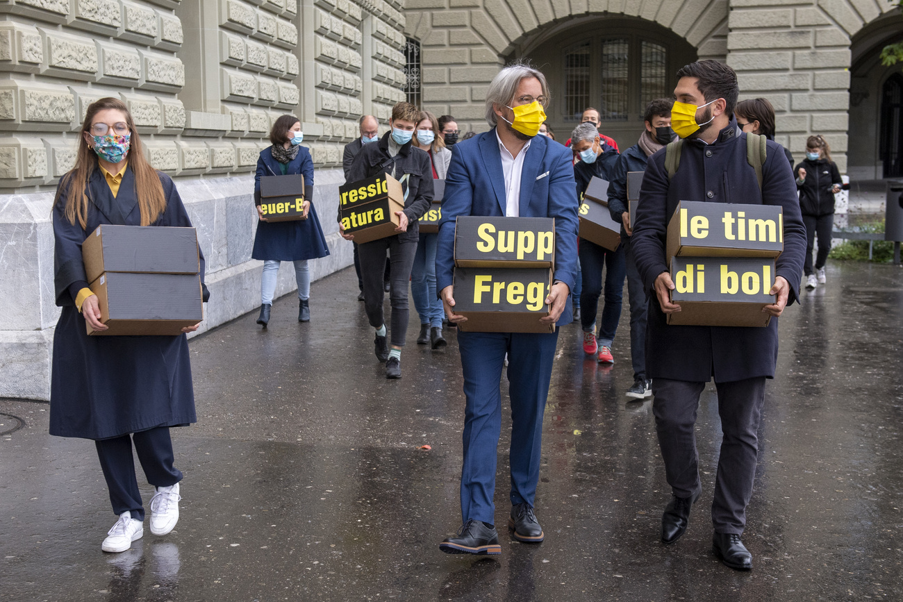 People carry boxes outside parliament