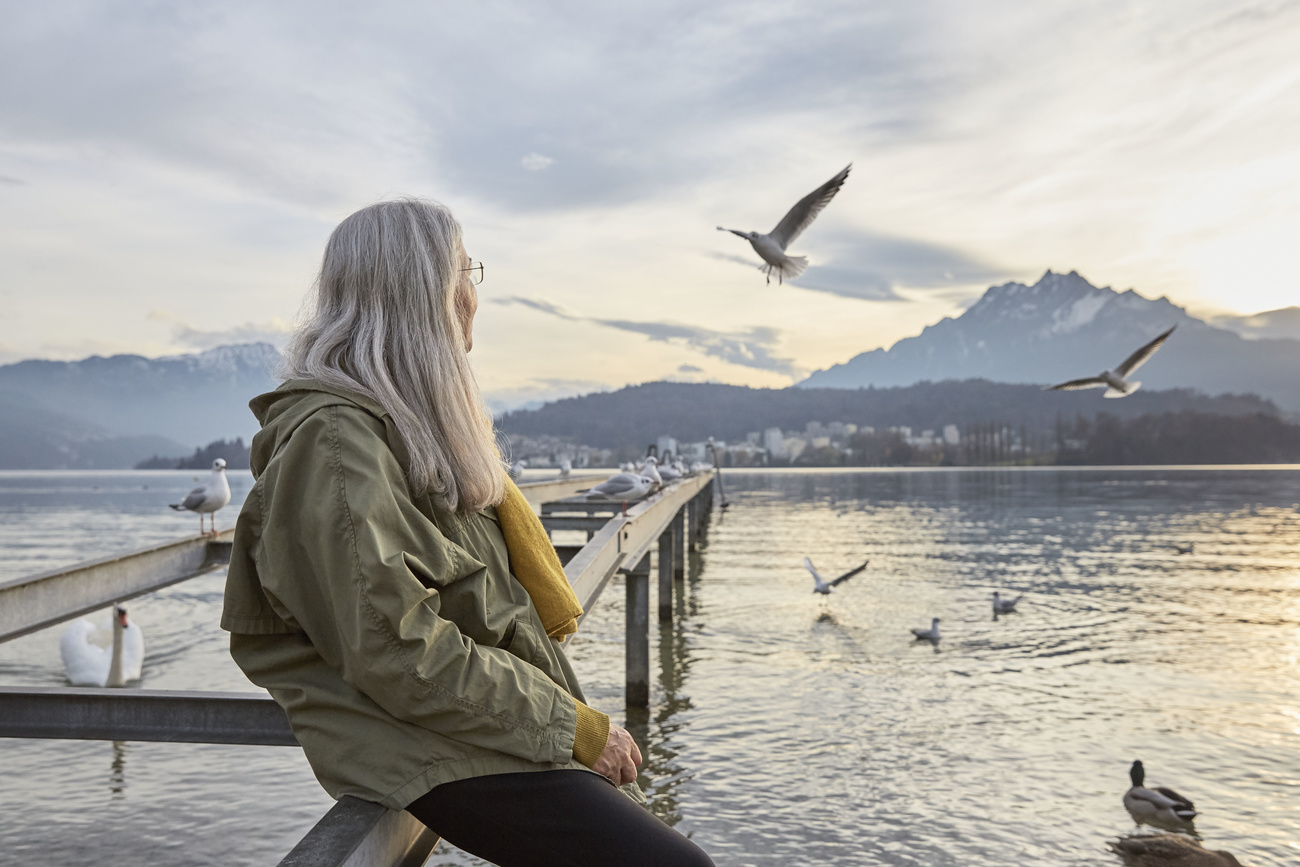 Old woman looking across a lake