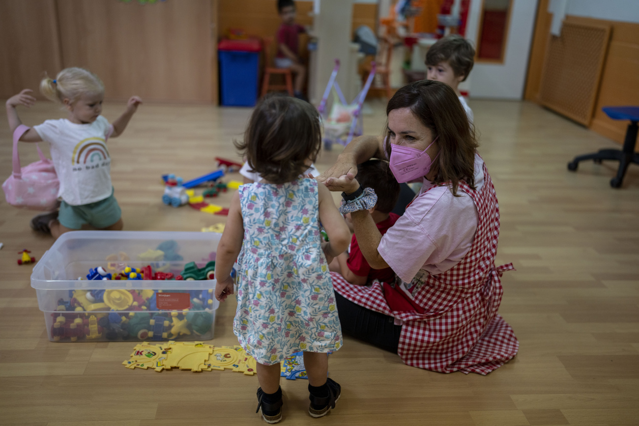 masked teacher with small kids