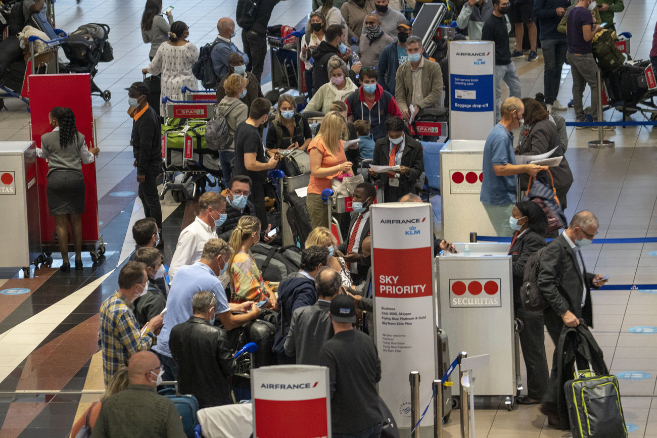 Passengers queue up to leave South Africa at Johannesburg s OR Tambo airport