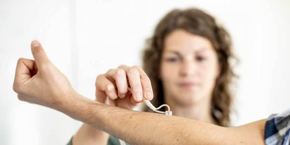 Woman using Nimble skin device on patient