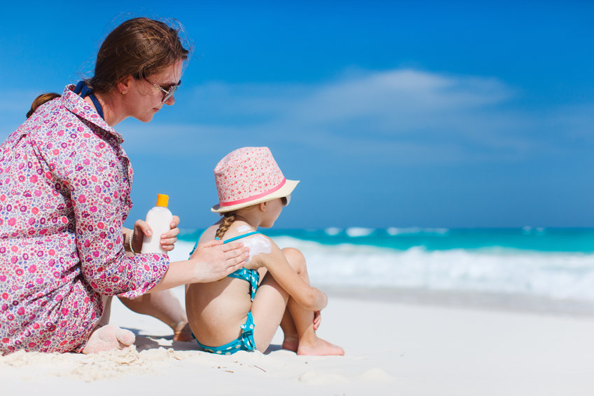 Mother and child using sun cream