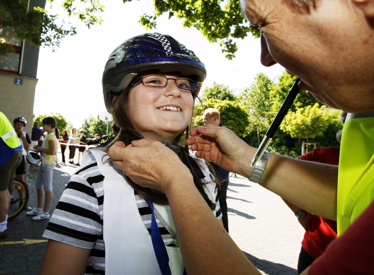 Schoolgirl getting a bike helmet