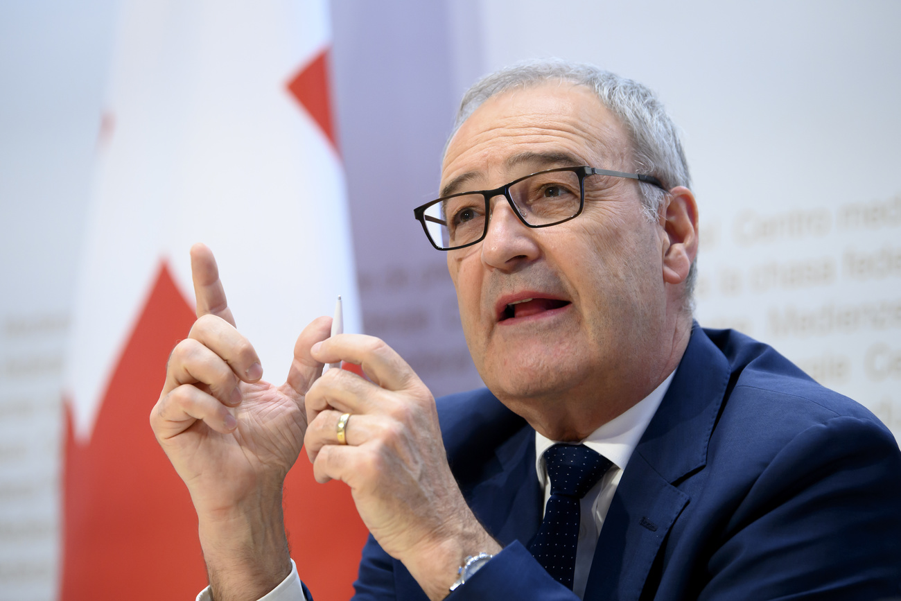 Economics Minister Parmelin and Swiss flag