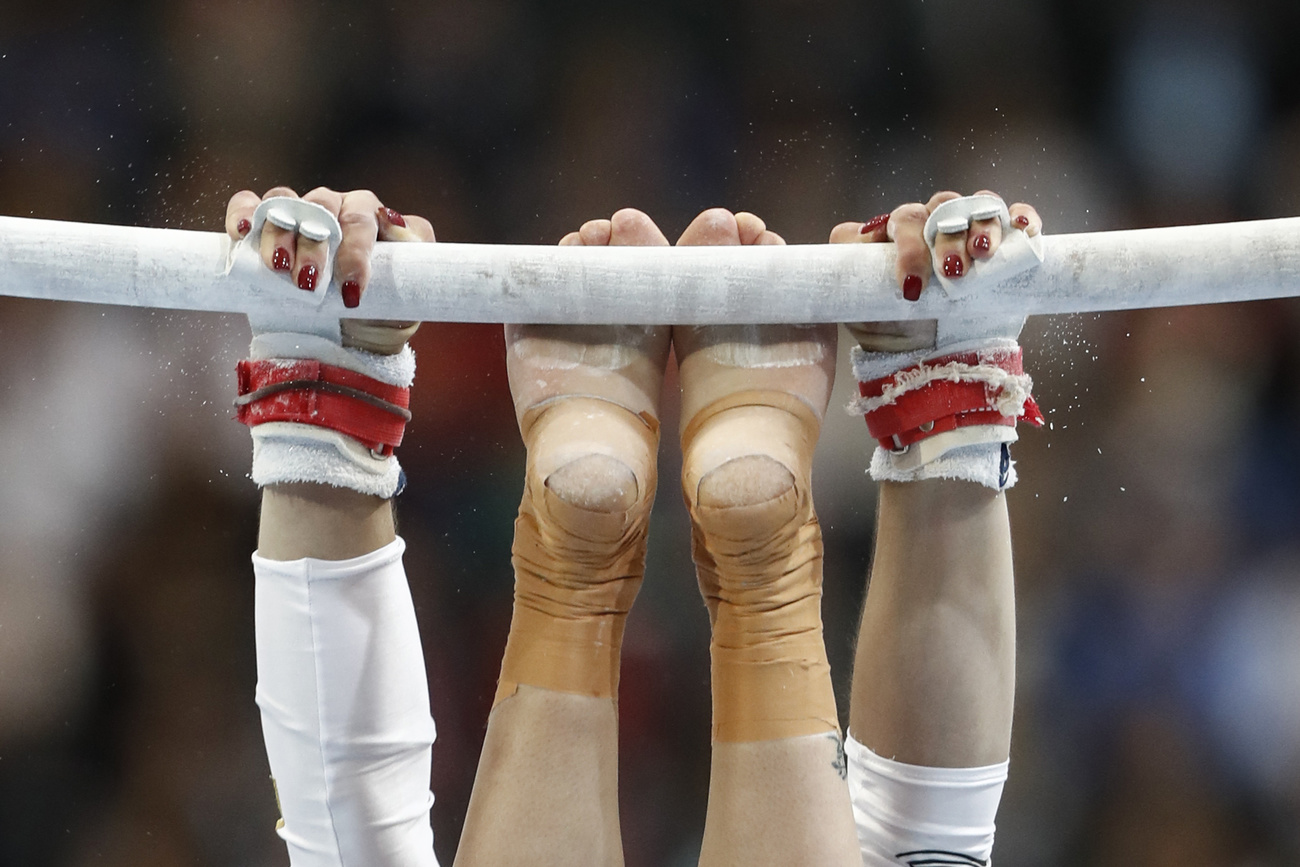 Female gymnast at bar.