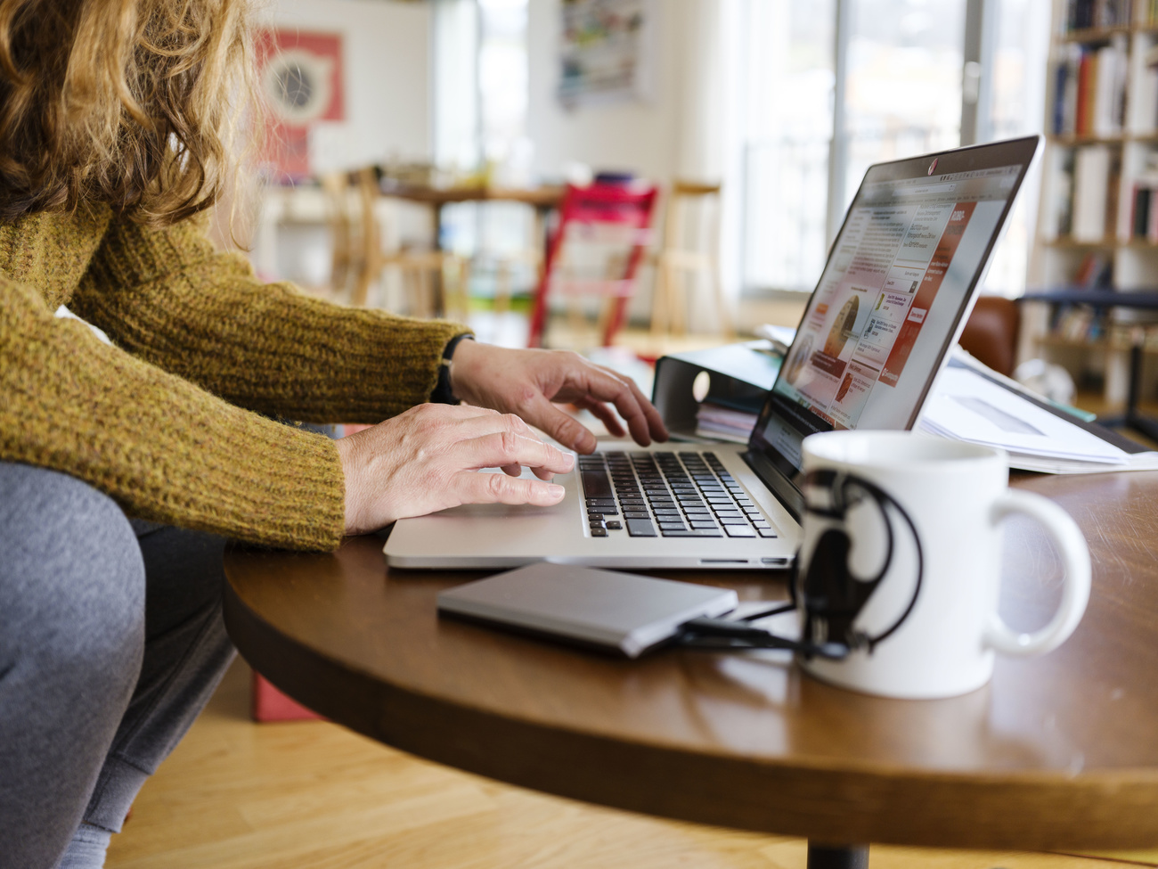 Woman with laptop computer in living room