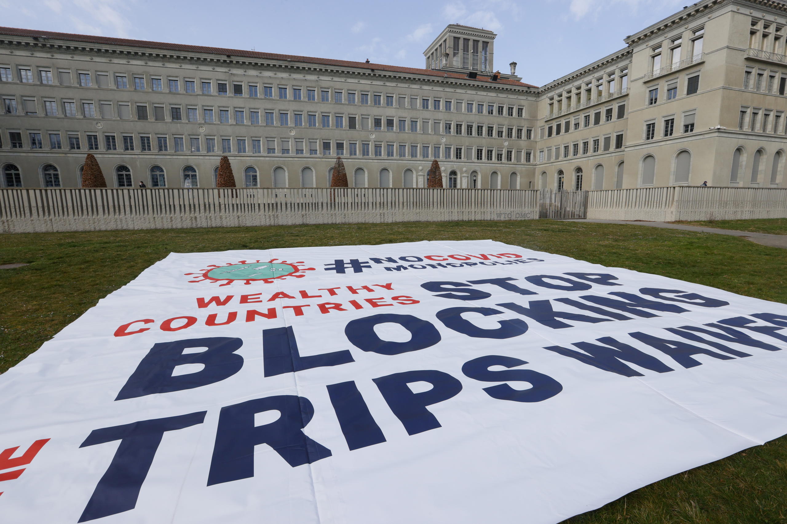 manifesto posato sul prato di fronte a un grande edificio