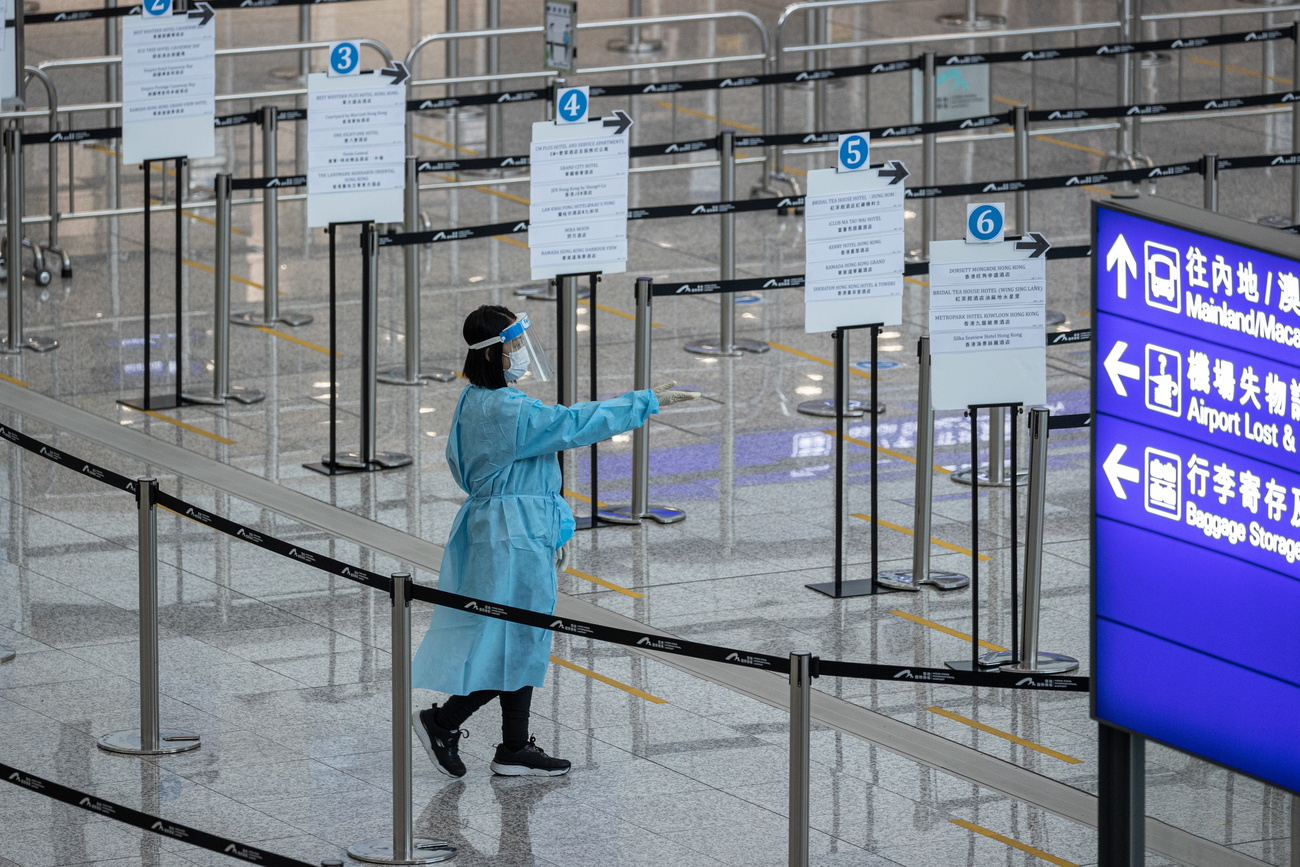health worker directing traffic at Hong Kong airport