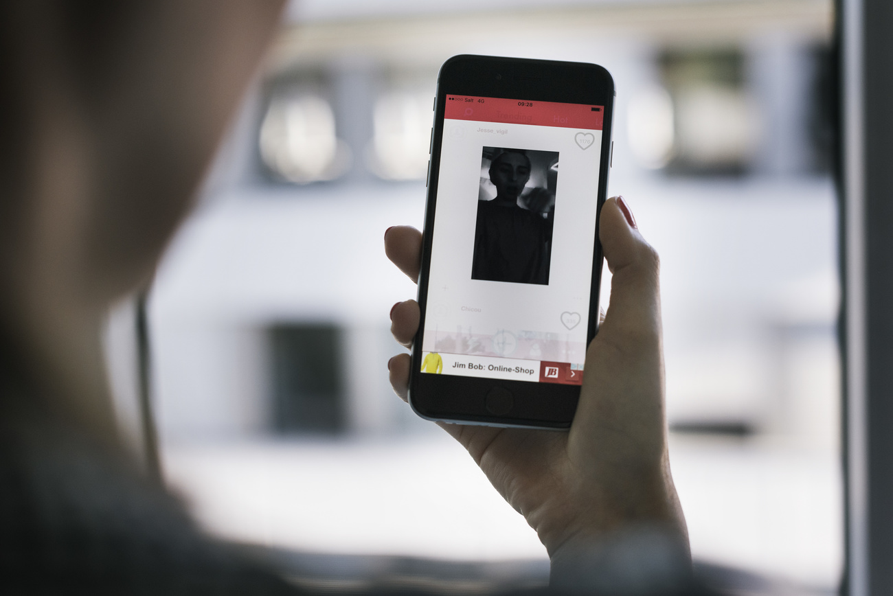 Person looks at shadowy figure displayed on their smartphone