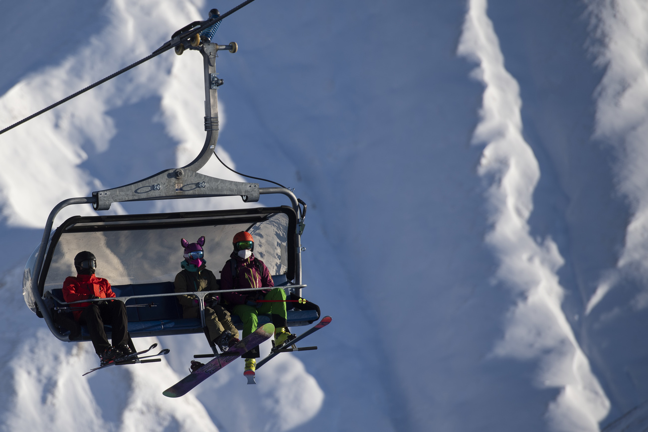 Skiers on a ski lift in Switzerland.