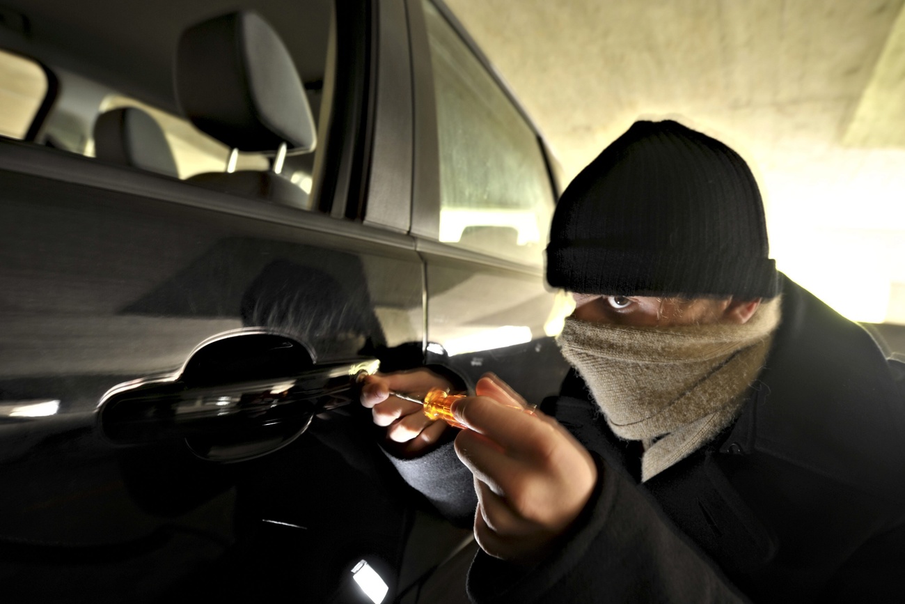 thief breaking into a car