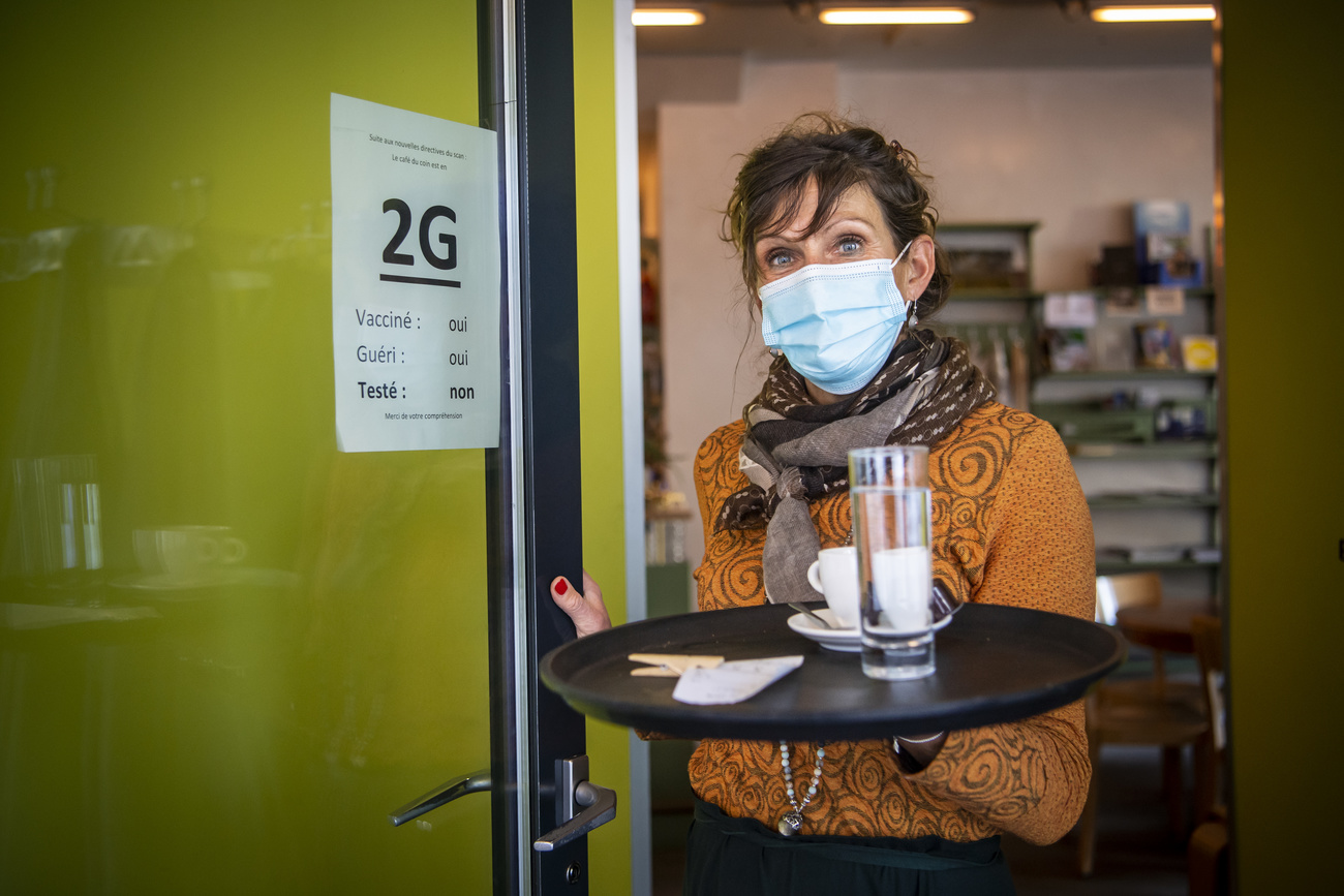 Waitress with mask serves a drink