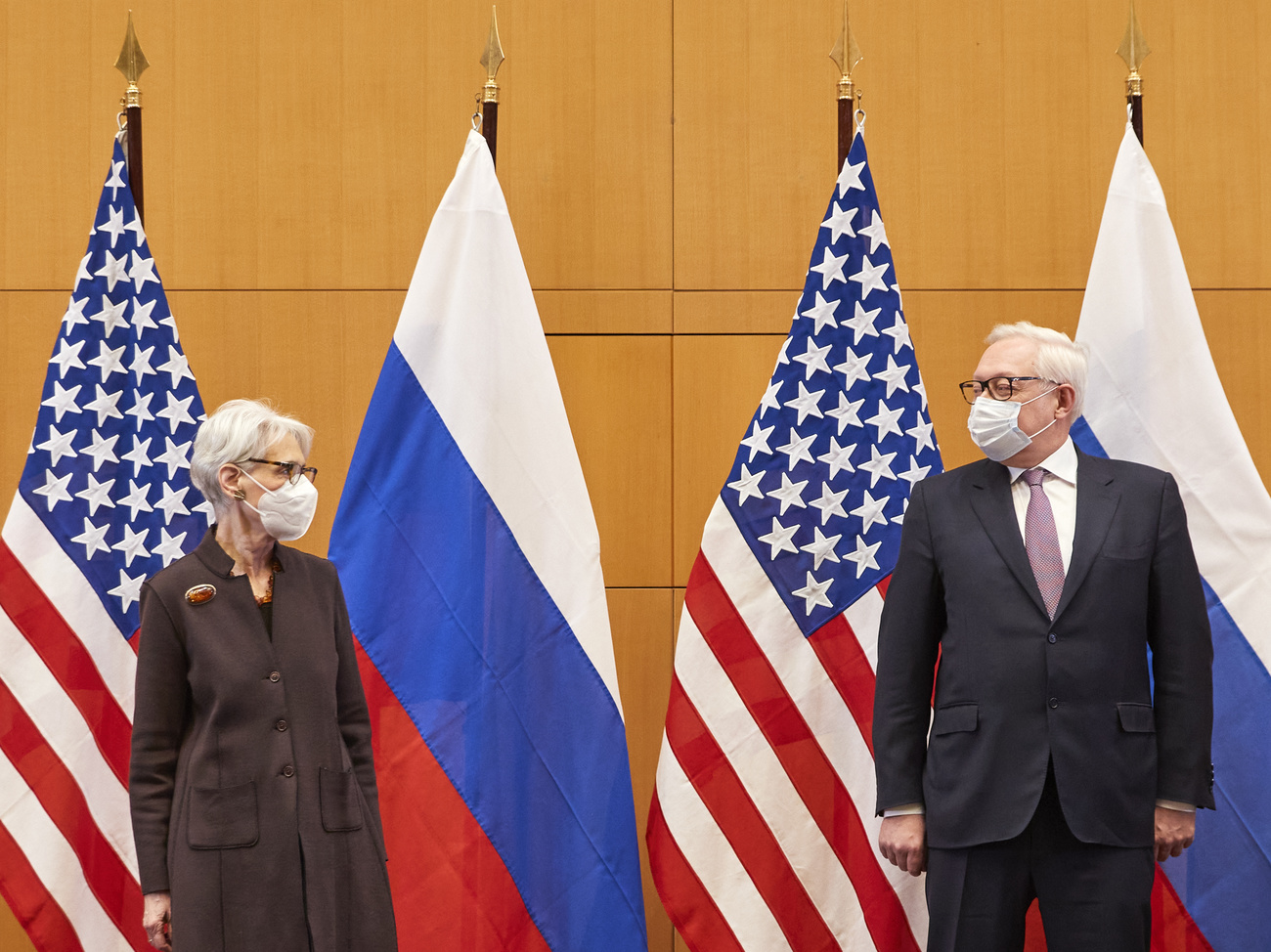 Deputy US Secretary of State Wendy Sherman and Russian Deputy Foreign Minister Sergei Ryabkov in front of US and Russian flags
