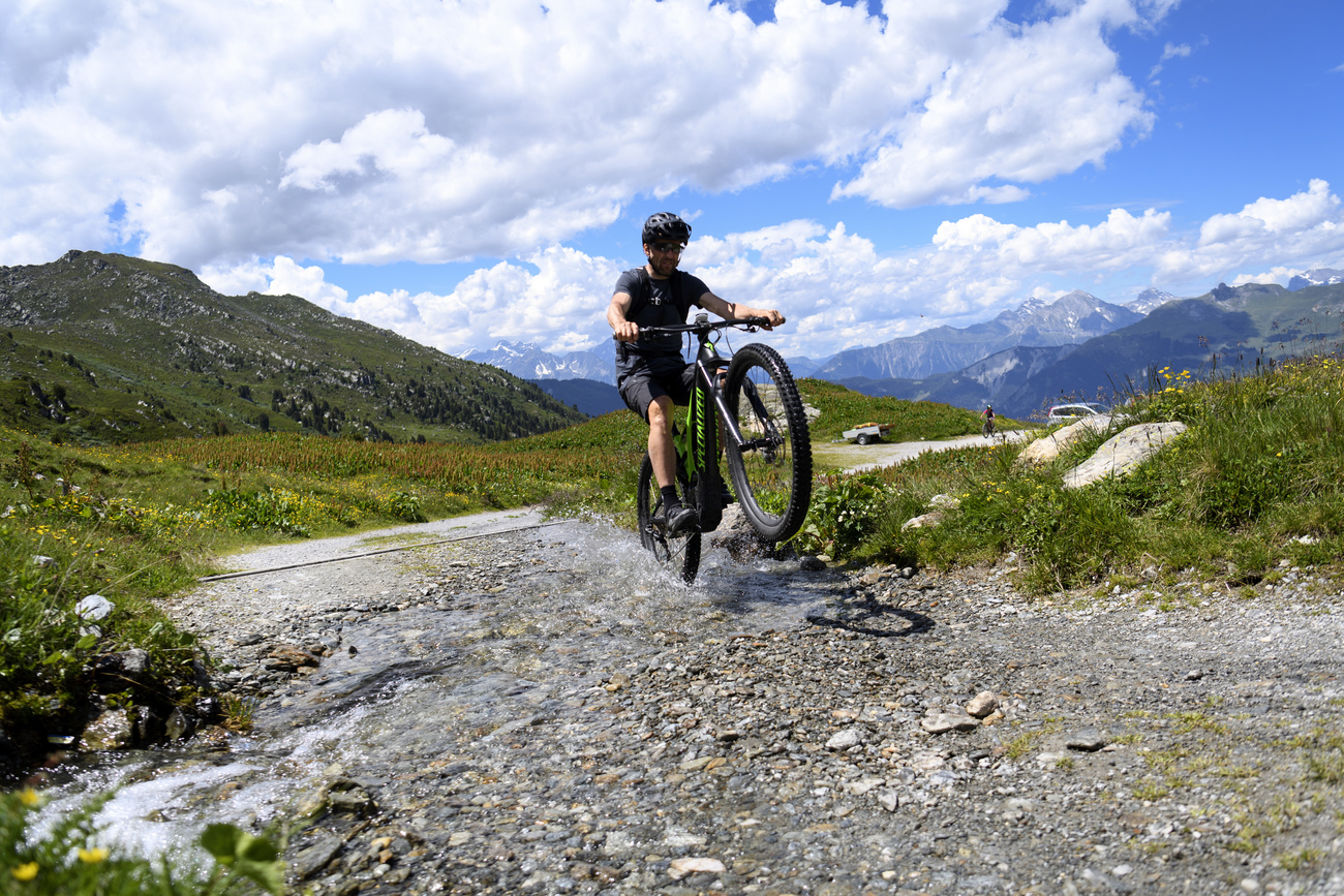 Man rides an e-bike in the Swiss mountains