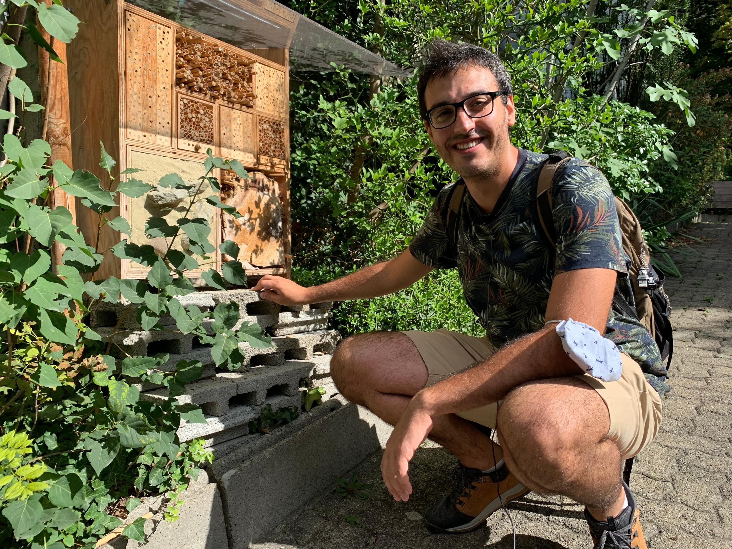 Man in front of an insect hotel