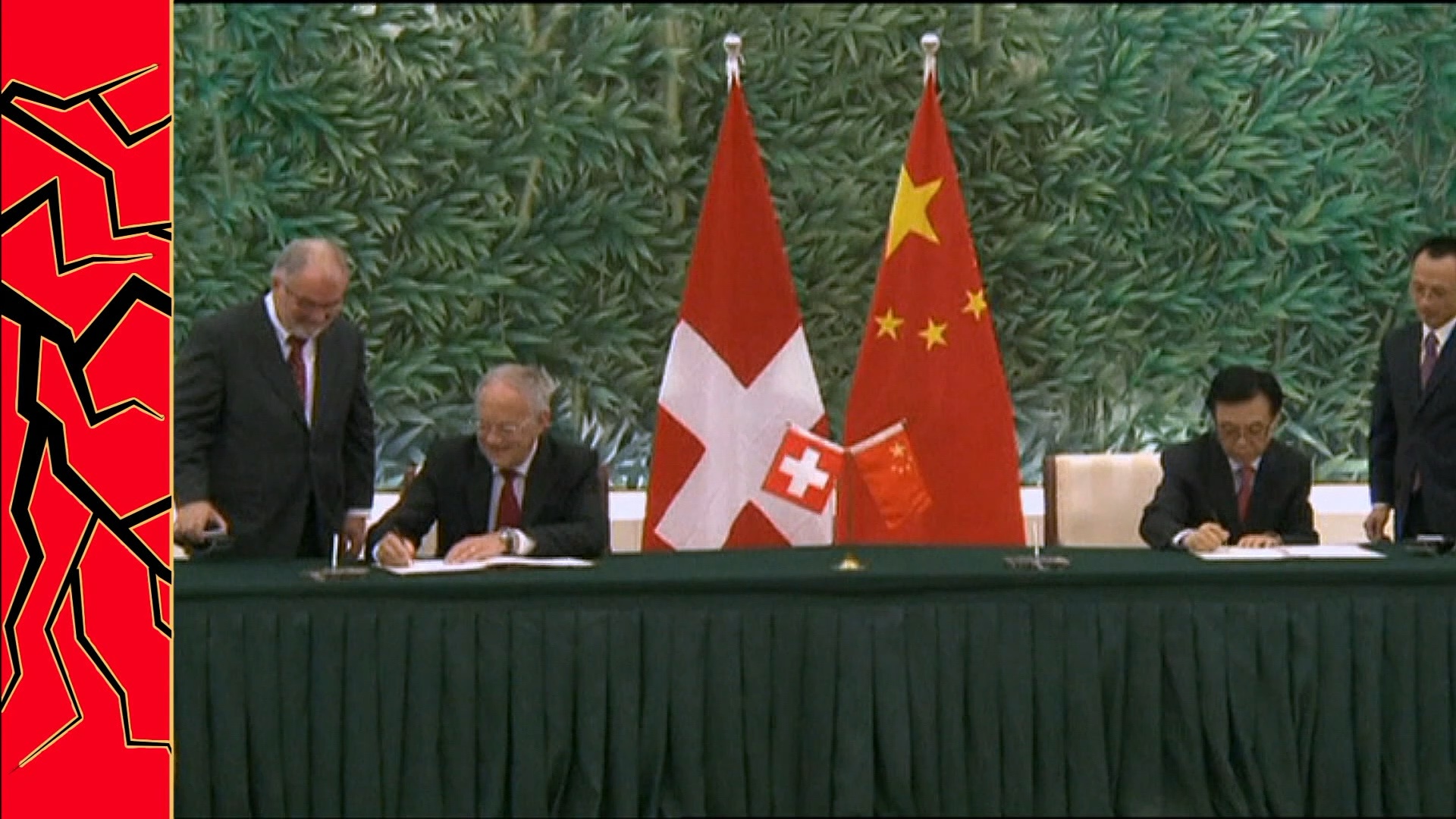 Swiss official signs document with Chinese official.