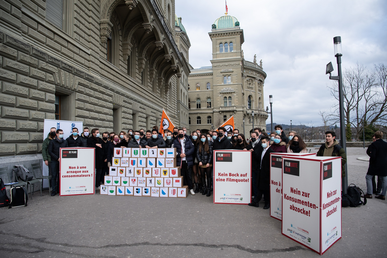 Campaigners against a levy on video streaming platform posing outside a government building