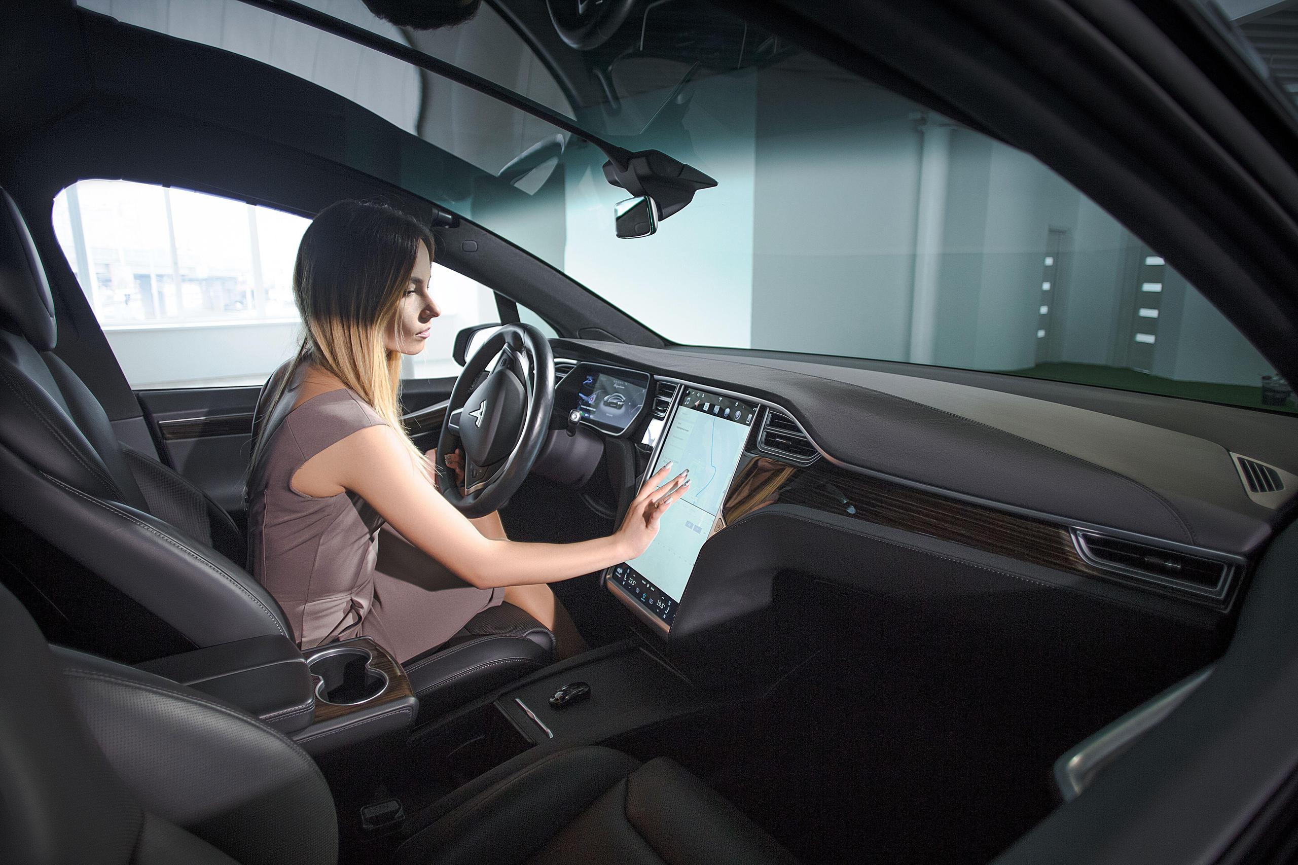 Woman driving an electric car.