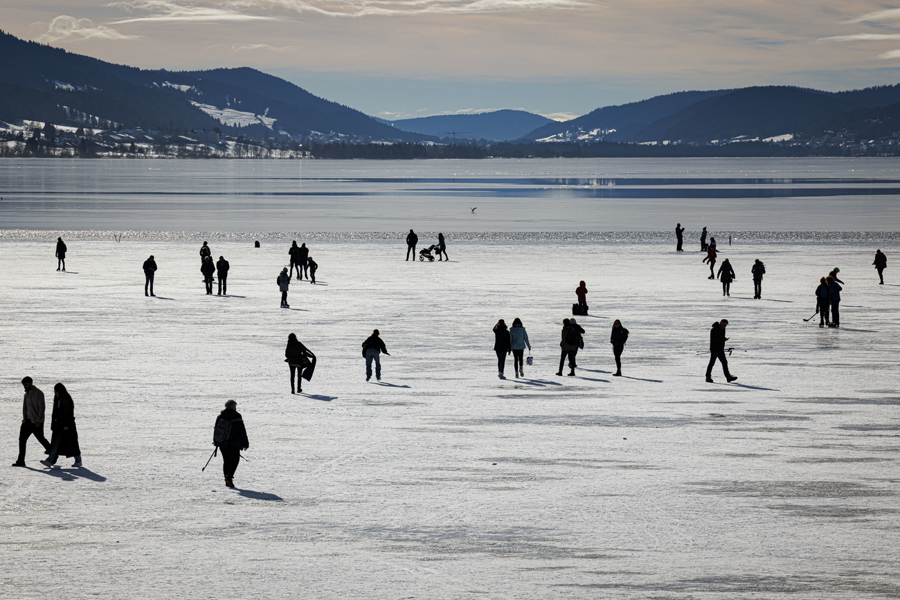 people walking on frozen lake