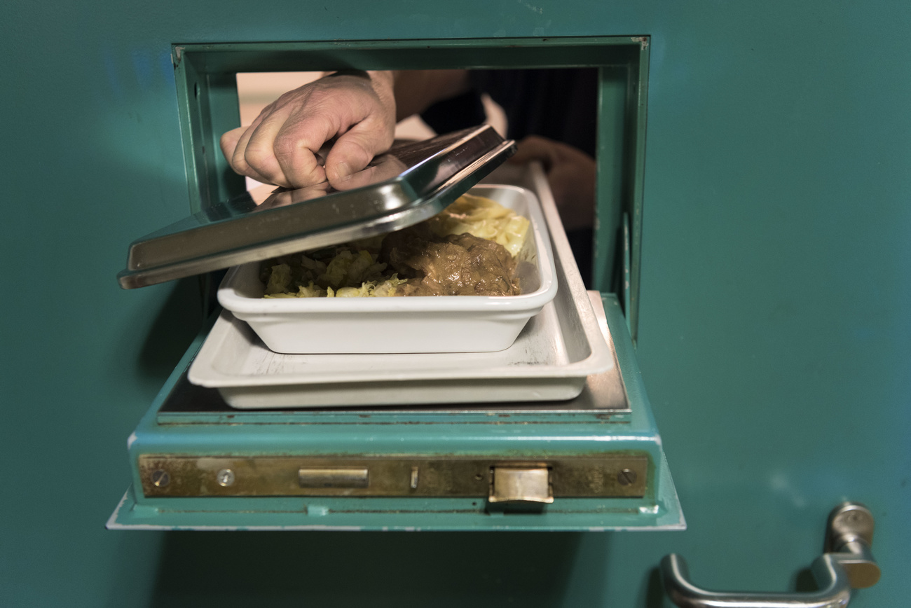 Food is served through a prison door hatch