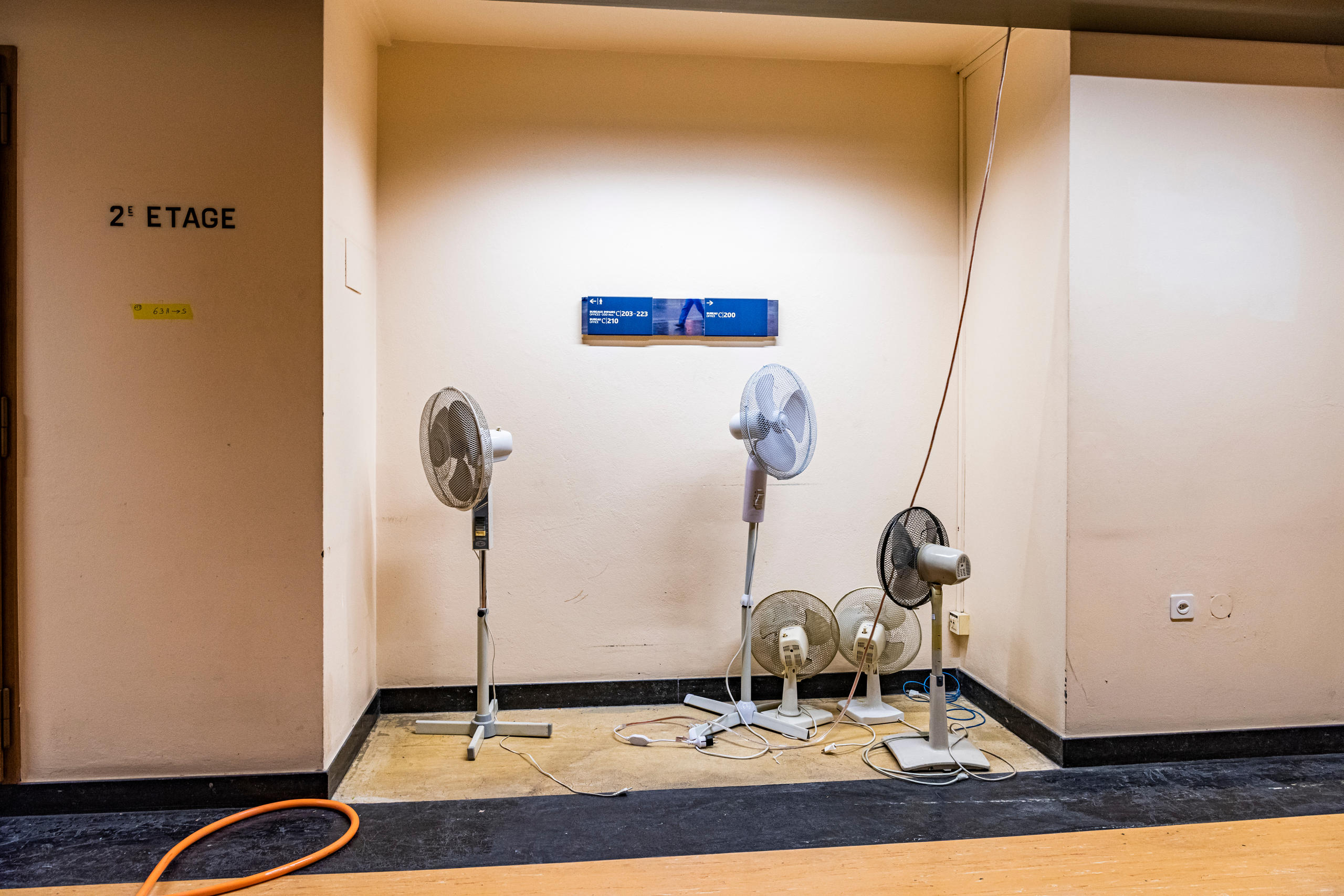 Abandoned fans in a corridor.