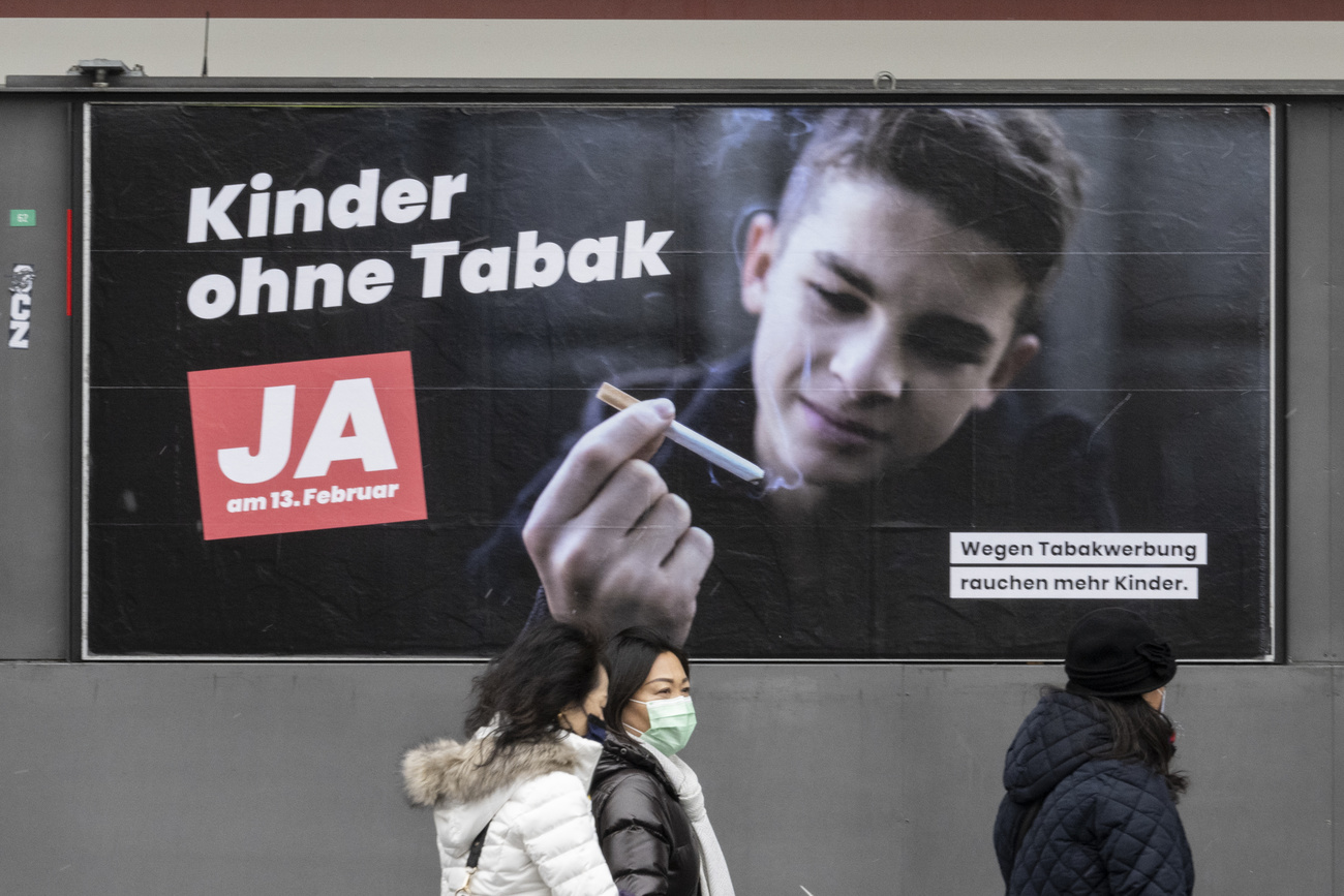 Campaign poster that reads: Children without tobacco. Vote yes on February 13. More children smoke because of tobacco ads.