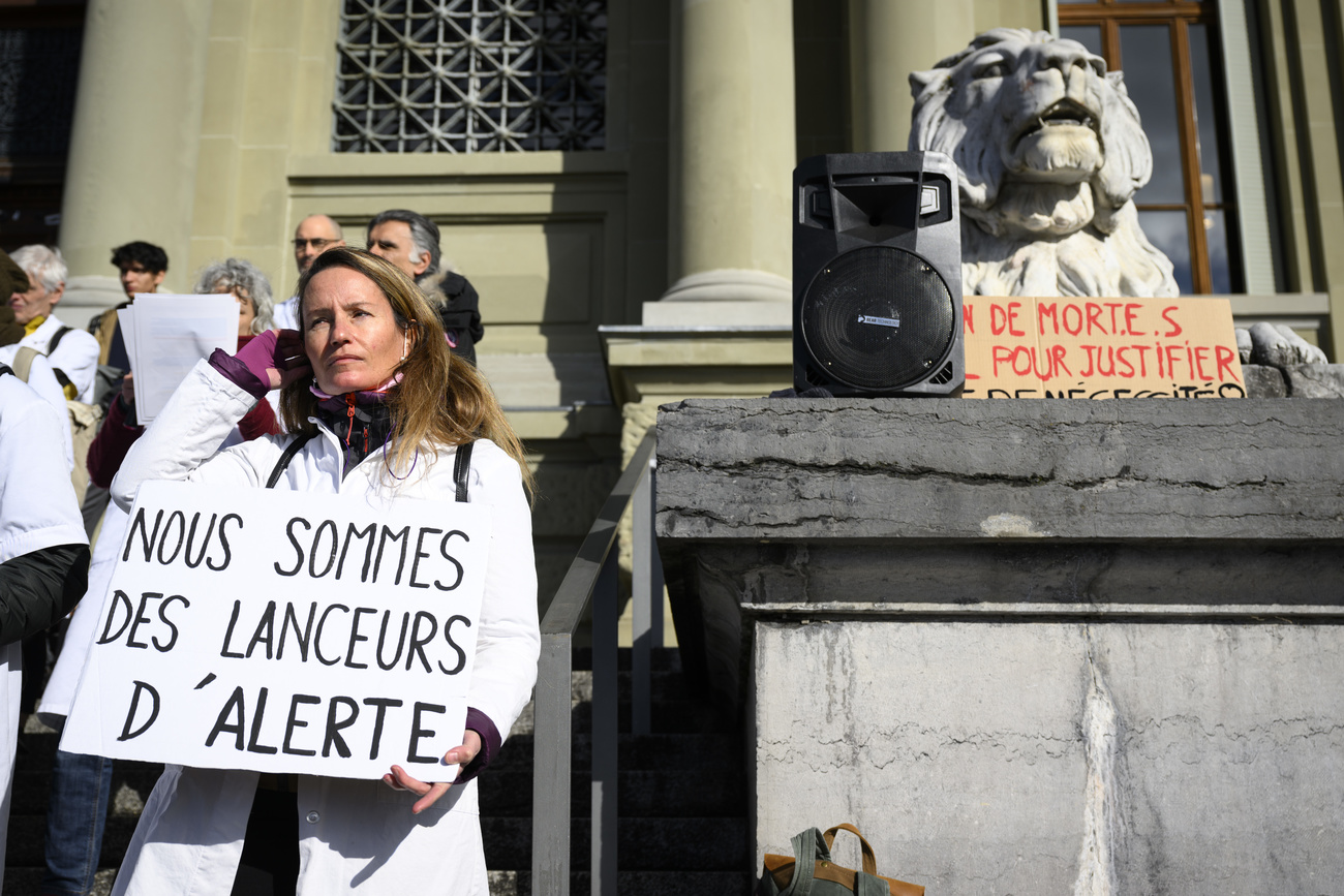 Demonstrators show their support for the defendants outside the court in Lausanne